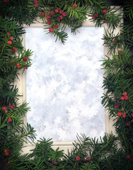 Creative layout made from Christmas tree branches with red berries and frame of window with snowflakes as paper card note. Copy space for text. Flat lay. Nature New Year concept.