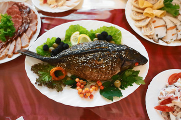 Catering service. Stuffed fish on the table Restaurant table with food on the table. Plates of food. Dinner time, lunch