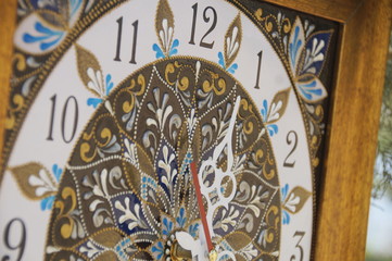 brown square hand-painted watch with contour acrylic paints in the technique point to point, with a geometric pattern in the form of a mandala, black numerals and white arrows