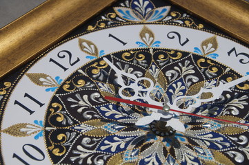 brown square hand-painted watch with contour acrylic paints in the technique point to point, with a geometric pattern in the form of a mandala, black numerals and white arrows
