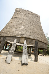 Fototapeta na wymiar A typical communal wooden house with straw roof of minority communities near Kon Tum, Vietnam
