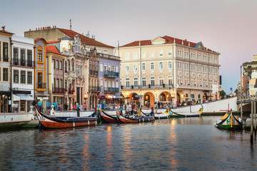 Central canal in Aveiro, with several moliceiros anchored and houses Art Noveau in the background. Center of the city of Aveiro, in Portugal.