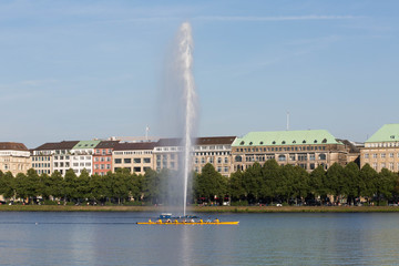 Fototapeta premium View of Alster lake, Hamburg, Germany, Fountain with a rainbow