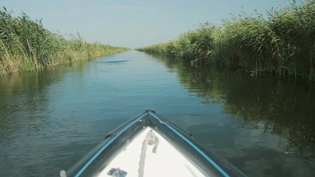 Landscape with waterline and boat from Letea village, in the Danube Delta area, Romania. Danube delta is the second largest river delta in Europe.