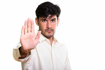 Fototapeta premium Studio shot of young Persian businessman with stop hand gesture