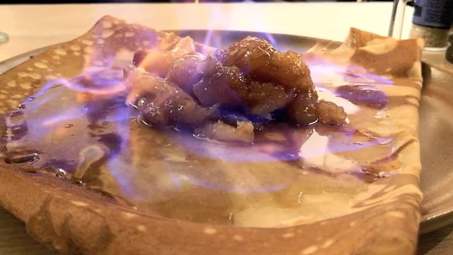 Crepe wird mit brennendem Apfelschnaps &uuml;bergossen und flambiert, full HD 1080p Video Footage