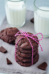 Chocolate brownie cookies with glasses of milk