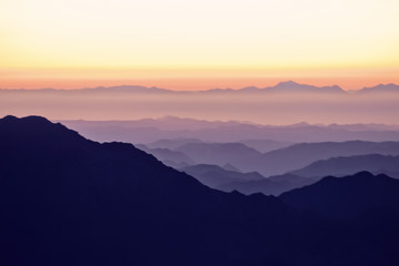 Fototapeta na wymiar Silhouette of mountains at sunset in the evening at dusk Mount Moses Sinai Egypt Landscape with aerial perspective, air fog