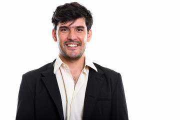 Studio shot of young happy Persian businessman smiling
