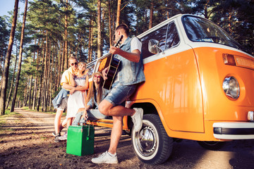 summer holidays, road trip, vacation, travel and people concept - smiling young hippie friends...