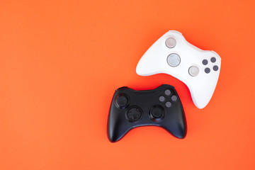 White and black joystick on a red background. Gamer concept. Controller for video games. Gamepad is isolated on a red background. Gaming competition © bodnarphoto