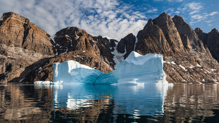 Arctic landscape in summer with high mountains  and iceberg in Scoresby Sound, East Greenland © Agata Kadar