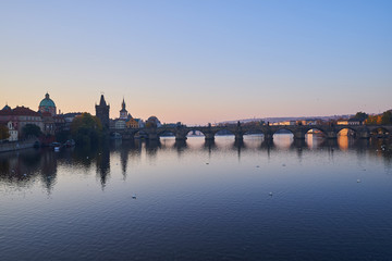 Fototapeta premium Landscape Picture of Charles bridge over Vltava river in Prague, capitol of Czech Republic in the morning during the sunrise, famous gothic style architecture in europe.