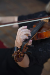 Girl playing the violin. Hand of a girl and a fiddle.