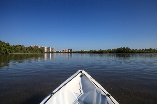 Kayak glides through water along the coastline of Marco Island, Florida