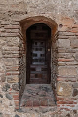Old wooden door in a brick wall