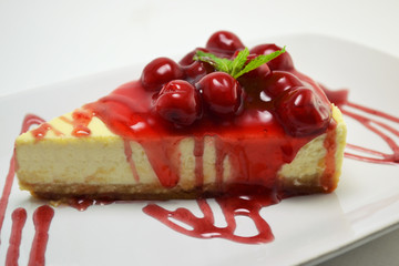 Cheesecake with Cherry on the Top Served on the White Plate Close-up. Pies of Berry Pie