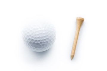 Golf ball and wooden tee on a white background