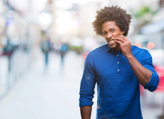 Afro american man over isolated background touching mouth with hand with painful expression because of toothache or dental illness on teeth. Dentist concept.