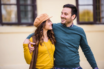Portrait of beautiful smiling love couple walking outdoors in the city