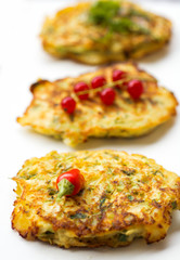 Vegetable zucchini pancakes, served with fresh herbs and garlic yogurt sauce, vegetarian  fritters 