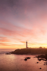 Pigeon Point lighthouse set against the setting sun