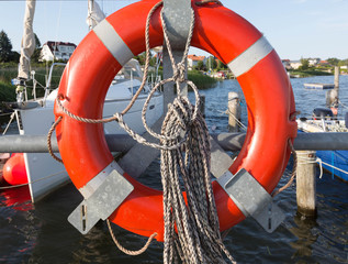 Red lifebuoy hanged near the sea