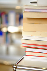 Stack of books on a shelf in a library