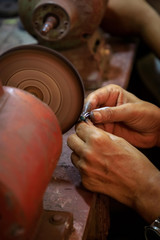 Jewelry smith polishes a lapis lazuli ring on a polishing machine in a backyard workshop in Puerto...