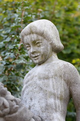 Stone figure, weathered, child on horse, detail, bridge town Hamm in Germany