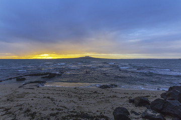 Landscape Scenery during Sunrise Time at Takapuna Beach, Auckland New Zealand; View to Rangitoto Island; Rough Seas