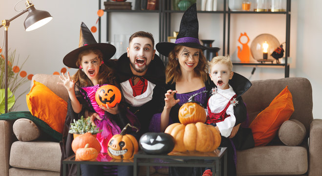 happy family mother father and children in costumes and makeup on  Halloween