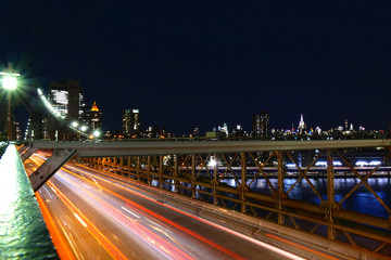 New York City skyline, Brooklyn Bridge traffic at night, Manhattan buildings and skyscrapers