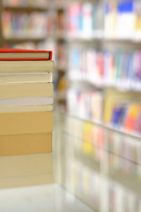 Stack of books on a shelf in a library