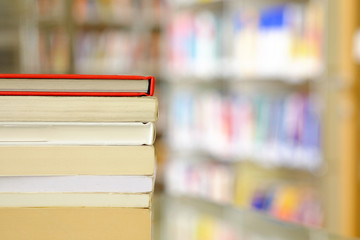 Stack of books on a shelf in a library