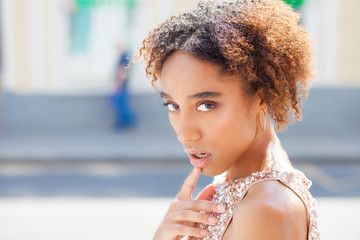 Portrait of beautiful natural young African woman in dress