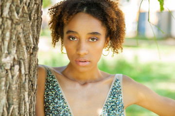 Portrait of beautiful natural young African woman in dress