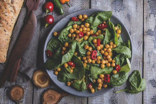 Chickpea and veggies salad with spinach leaves, healthy homemade vegan food, diet.