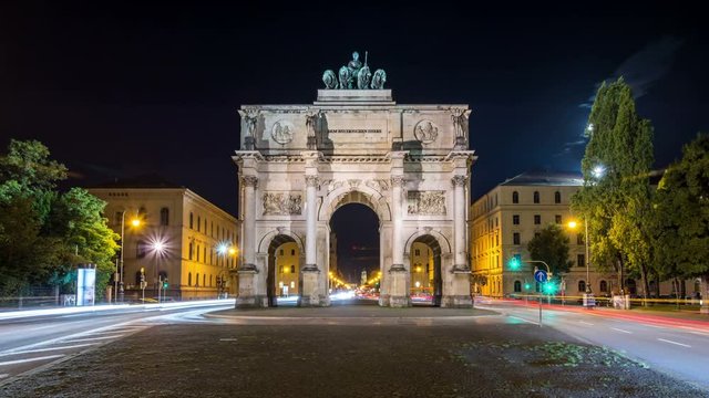 The Siegestor (Victory Gate), a three-arched triumphal arch crowned with a statue of Bavaria with a lion quadriga, Munich, Germany. Night time lapse video.