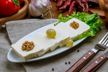 Suluguni cheese sliced on a plate