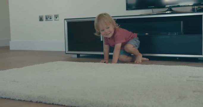 Mother and toddler doing roly-polies at home