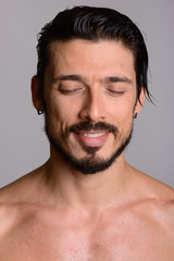 Obraz premium Face of happy handsome man smiling with eyes closed shirtless