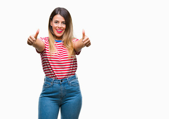 Young beautiful woman casual look over isolated background approving doing positive gesture with hand, thumbs up smiling and happy for success. Looking at the camera, winner gesture.