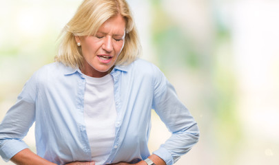 Obraz premium Middle age blonde woman over isolated background with hand on stomach because indigestion, painful illness feeling unwell. Ache concept.