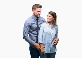 Young workers business couple over isolated background looking away to side with smile on face, natural expression. Laughing confident.