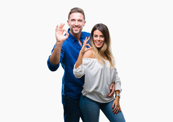 Obraz na płótnie Canvas Young couple in love over isolated background smiling positive doing ok sign with hand and fingers. Successful expression.