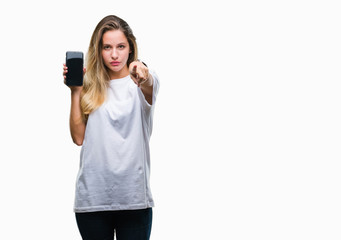 Young beautiful blonde woman showing screen of smartphone over isolated background pointing with finger to the camera and to you, hand sign, positive and confident gesture from the front