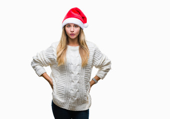 Young beautiful blonde woman wearing christmas hat over isolated background afraid and shocked with surprise expression, fear and excited face.