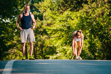 Naklejka premium Couple doing stretching exercise after jogging