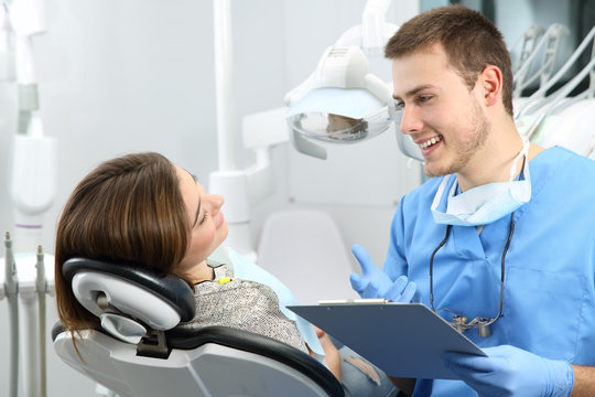 Dentist explaining dental treatment procedure to a patient